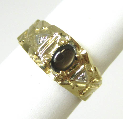 Appraisal: BLACK STAR SAPPHIRE AND DIAMOND RING k yellow gold with