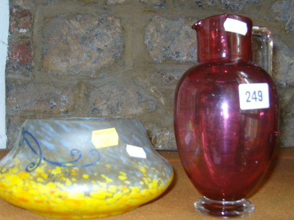 Appraisal: A Victorian cranberry glass jug with angular handles together with