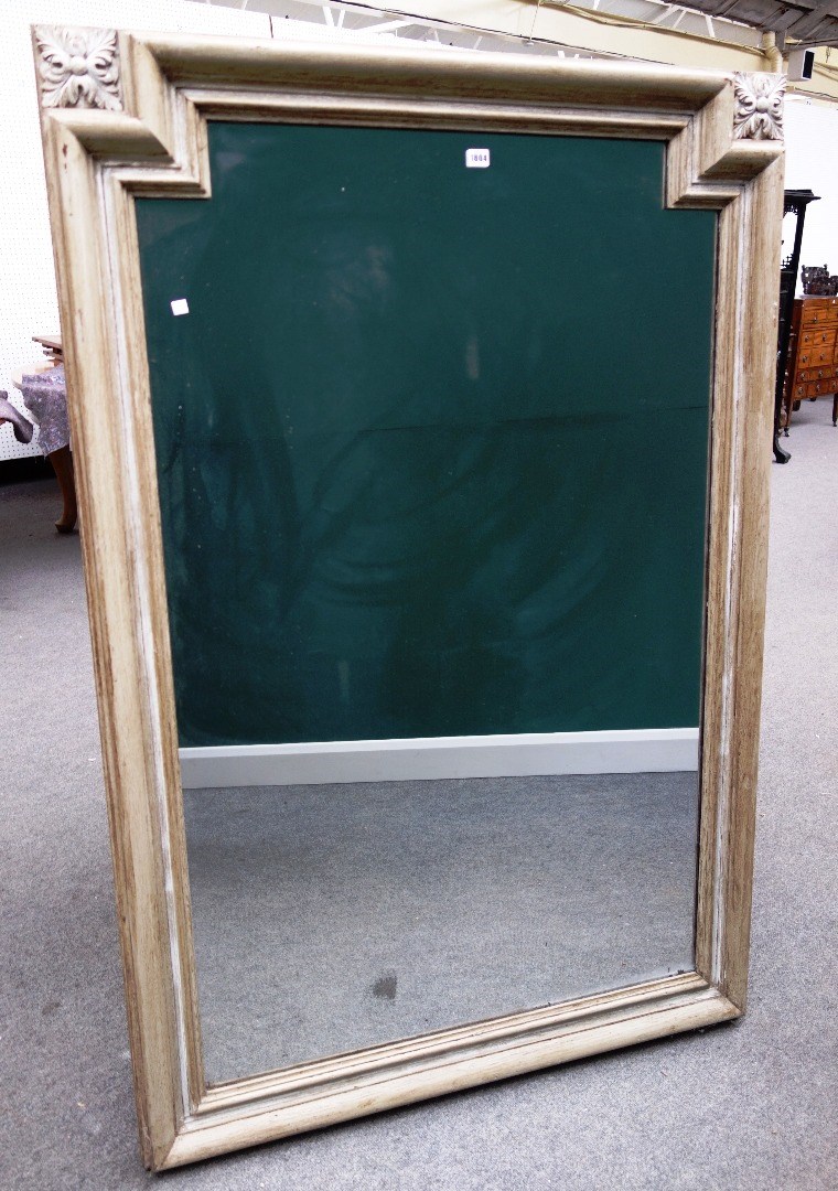 Appraisal: A cream painted rectangular wall mirror the crest rail with