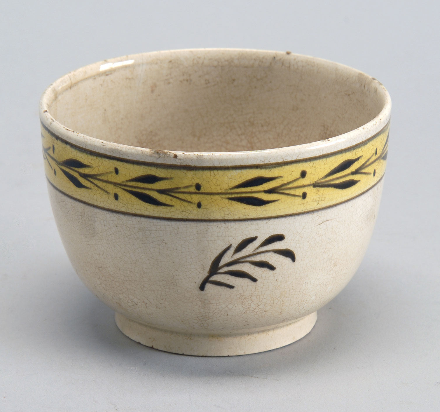 Appraisal: TH CENTURY YELLOWWARE BOWL with yellow band and floral decoration