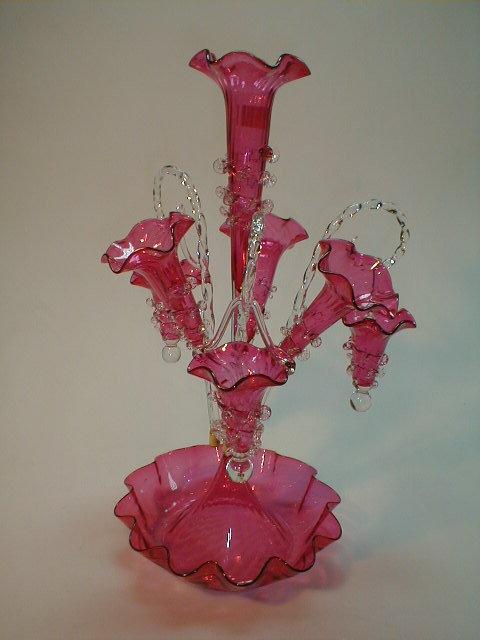 Appraisal: A modern cranberry glass epergne with three trumpets and three