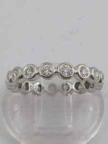 Appraisal: A white metal tests ct gold diamond eternity ring Approx