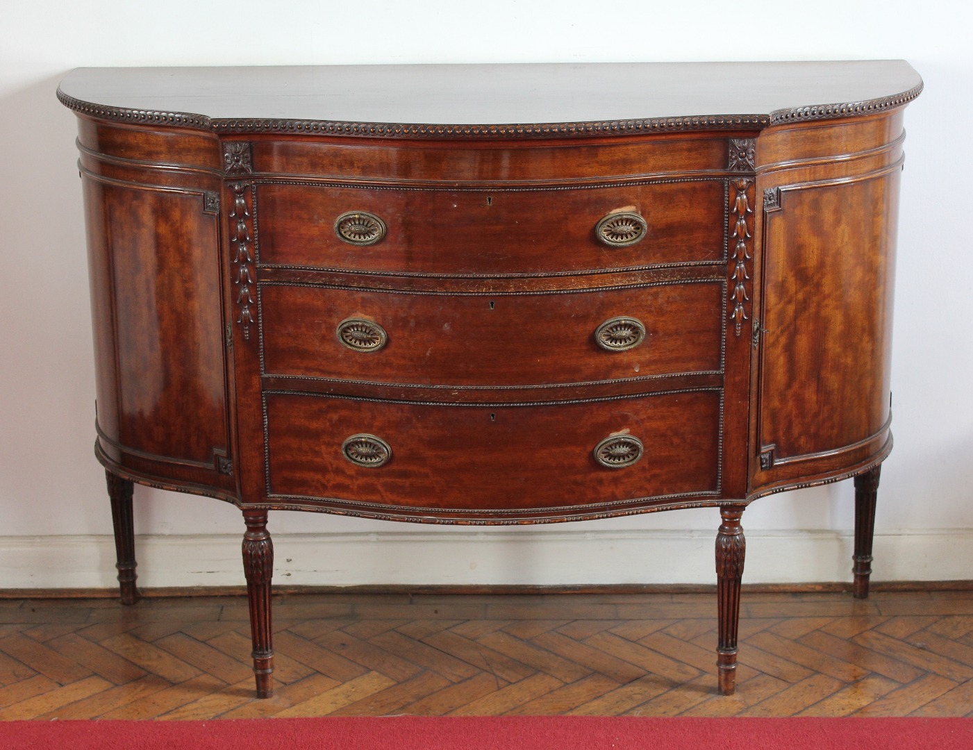 Appraisal: A George V small mahogany serpentine front sideboard in the