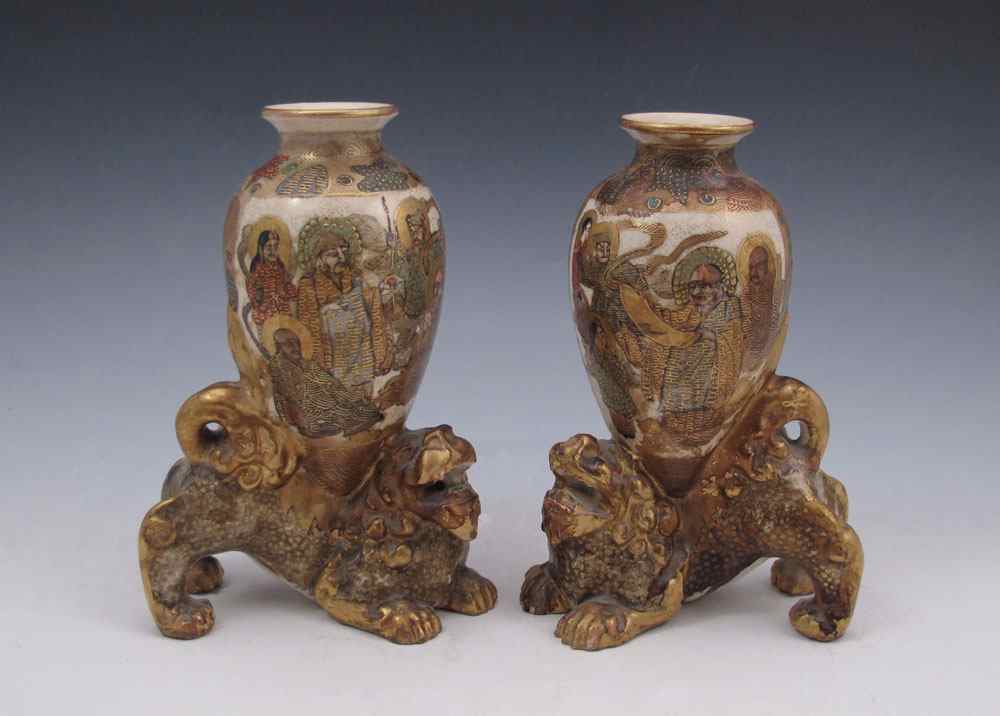 Appraisal: PAIR JAPANESE SATSUMA FOO LION VASES Hand painted saints scholars