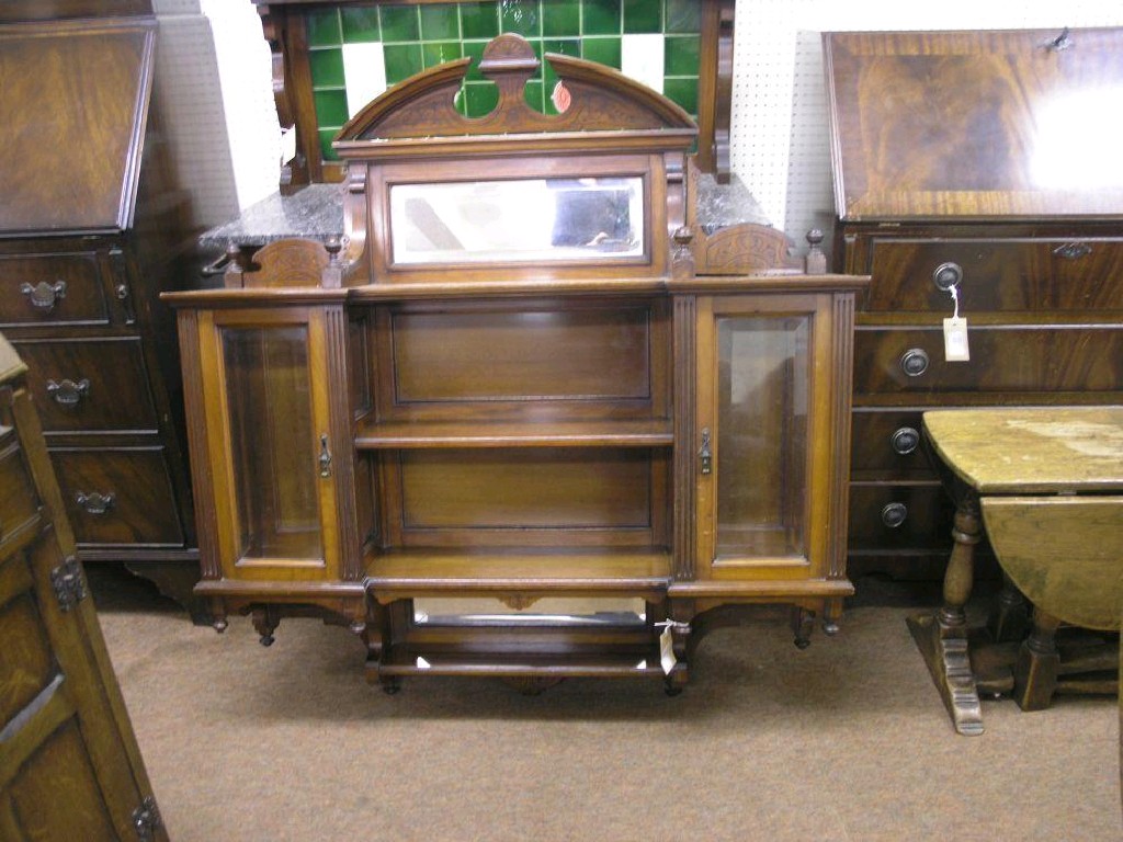 Appraisal: A late Victorian solid walnut wall-hanging cabinet arched pediment above