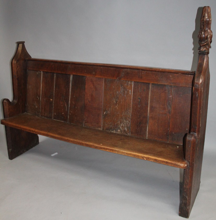 Appraisal: A thC stained oak and pine pew with a shelf