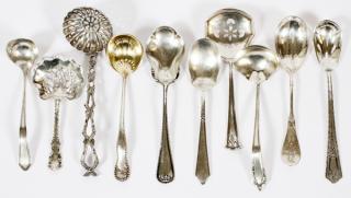 Appraisal: STERLING FANCY SUGAR SPOONS PLUS PIERCED NUT SPOONS All nine