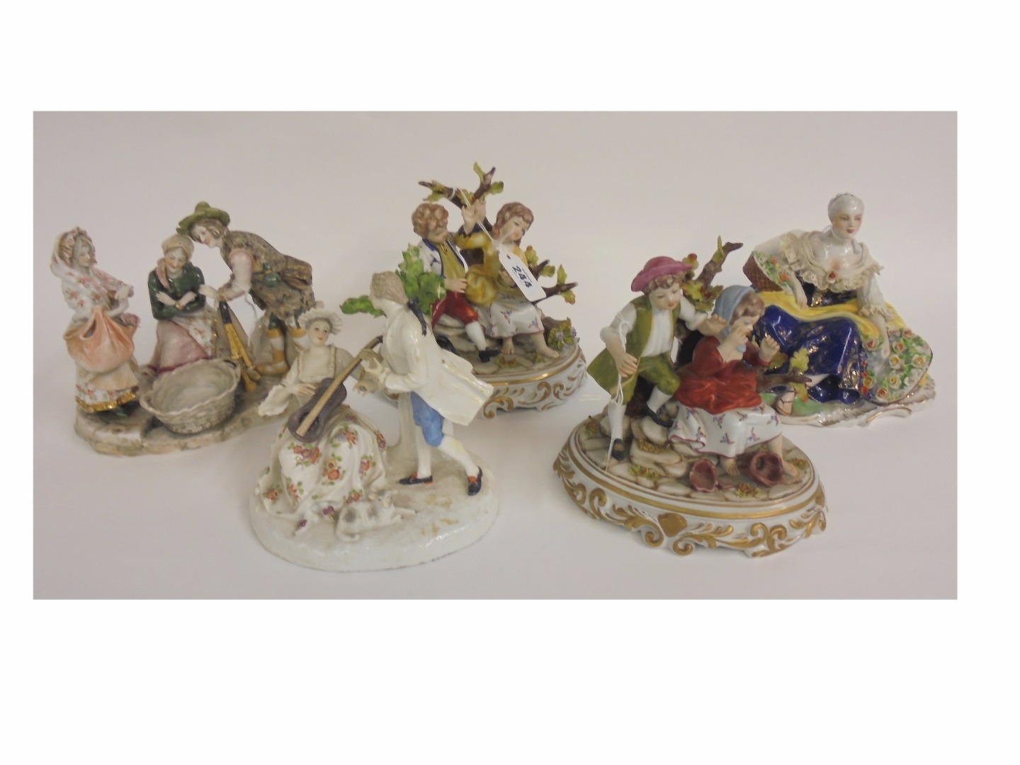 Appraisal: A pair of Italian porcelain groups of children seated on