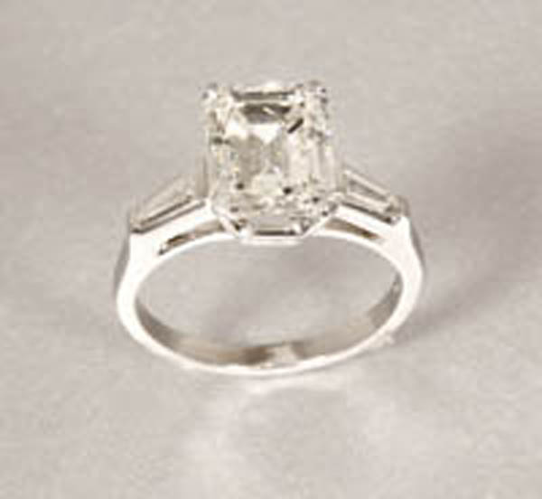 Appraisal: An emerald-cut diamond ring An emerald-cut diamond ring Platinum centering