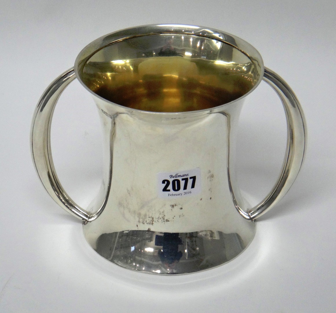 Appraisal: A silver twin handled loving cup on slender waisted plain