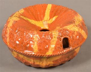 Appraisal: th Century Molded Redware Cuspidor Orange ground with yellow and