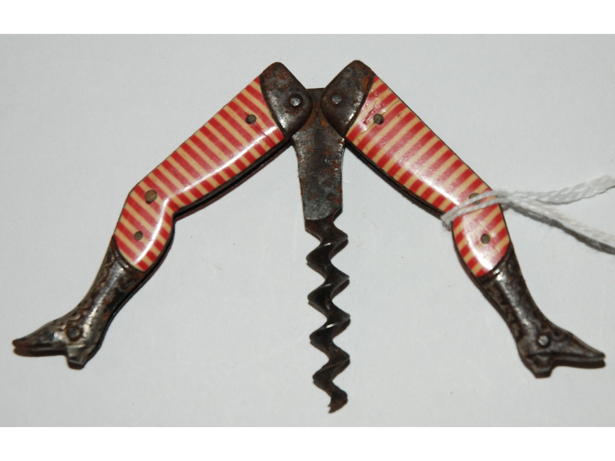 Appraisal: A corkscrew modelled as a Victorian lady's legs in striped