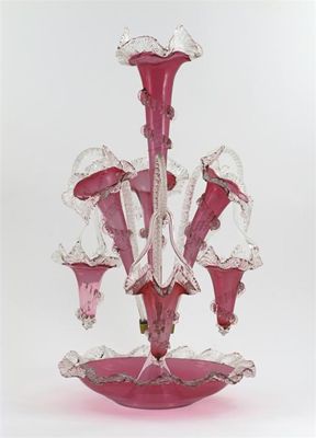 Appraisal: A cranberry glass pergne with three trumpets and three suspended