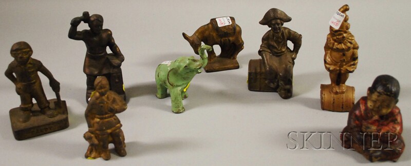 Appraisal: Eight Small Painted Cast Iron Figural Doorstops a boy with