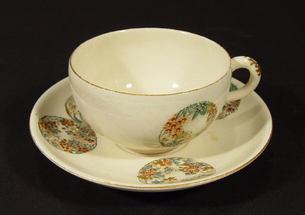 Appraisal: Japanese Satsuma pottery teacup and saucer enamelled with circular panels