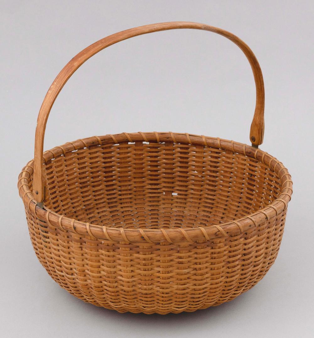 Appraisal: NANTUCKET BASKET th Century Round with swing handle An older