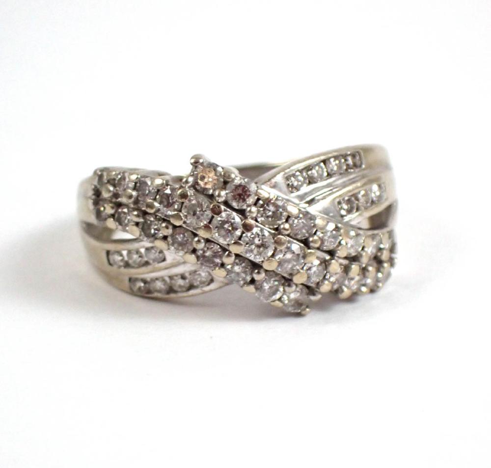 Appraisal: DIAMOND AND FOURTEEN KARAT WHITE GOLD RING having a cross