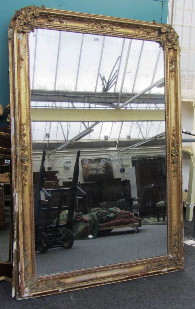 Appraisal: A large th century gilt framed wall mirror of rounded