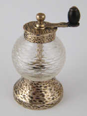 Appraisal: A late Victorian hammered finish silver mounted cut glass pepper