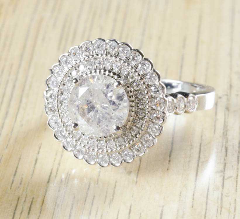 Appraisal: ESTATE DIAMOND AND FOURTEEN KARAT WHITE GOLD RING with two