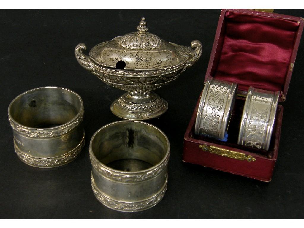 Appraisal: Pair of s silver napkin rings with embossed scrolling bands