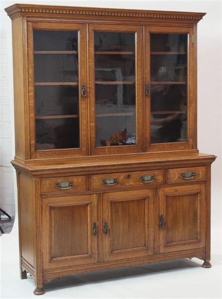 Appraisal: A late Victorian oak three door bookcase and undercabinet the