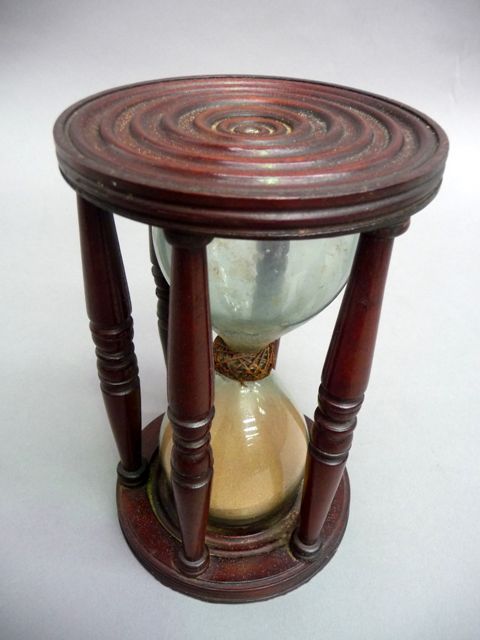 Appraisal: A Georgian mahogany sand timer with turned top and base