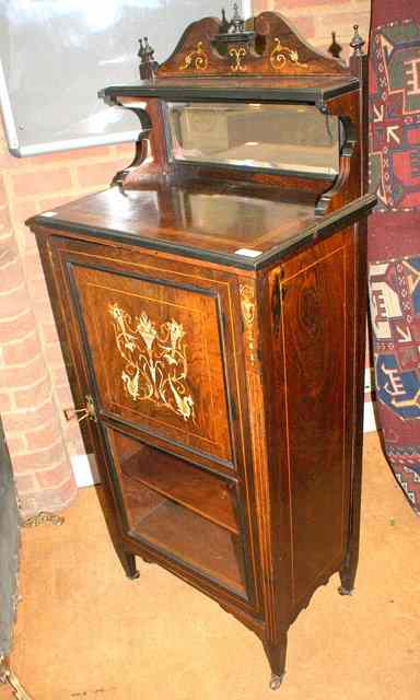 Appraisal: AN EDWARDIAN ROSEWOOD MUSIC CABINET the interior fitted shelves enclosed