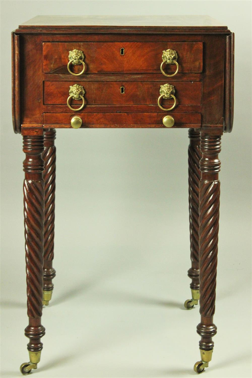 Appraisal: A CLASSICAL CARVED MAHOGANY TWO DRAWER SEWING TABLE NEW YORK