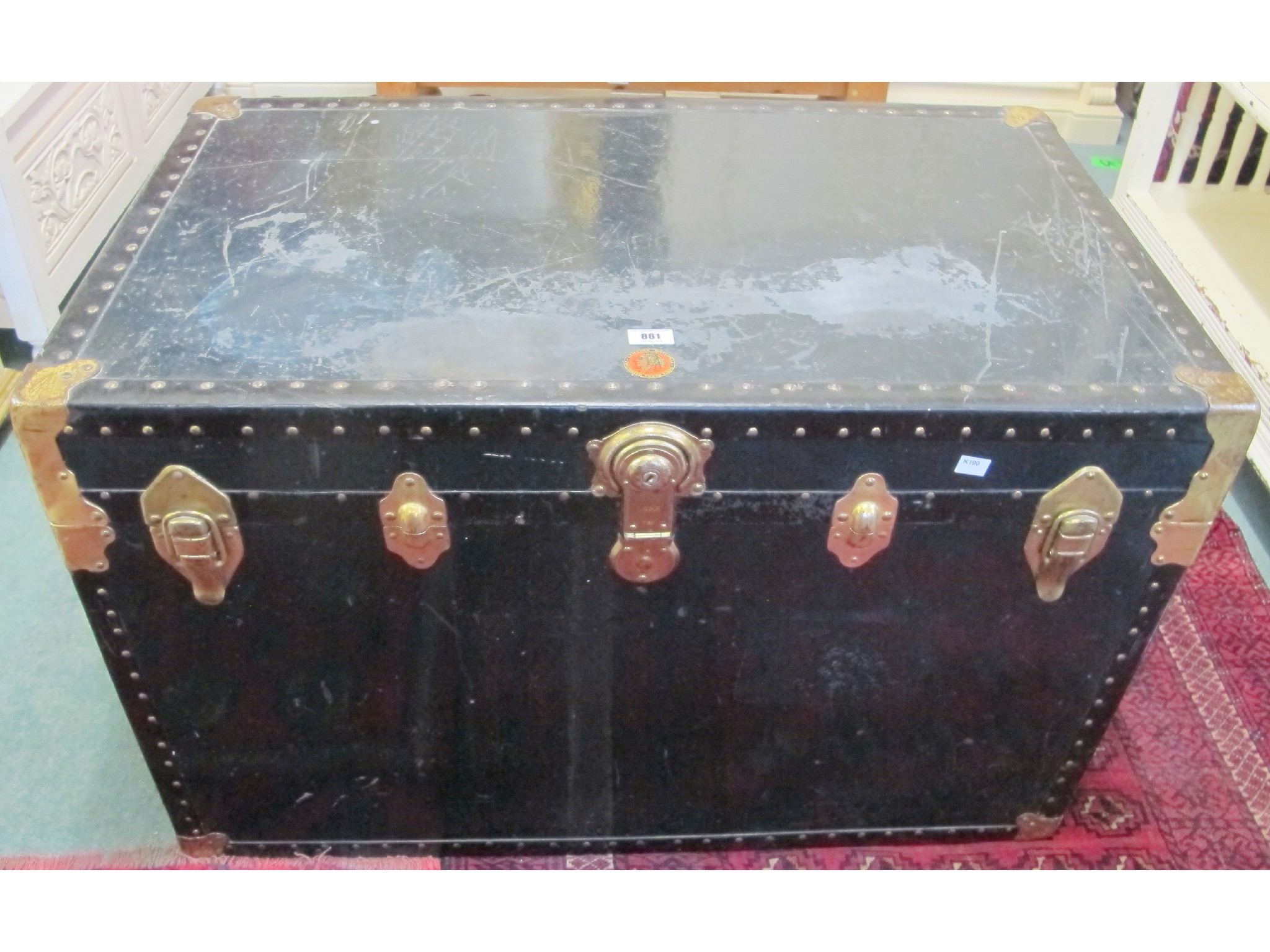 Appraisal: A brass and black genuine national vulcanized trunk