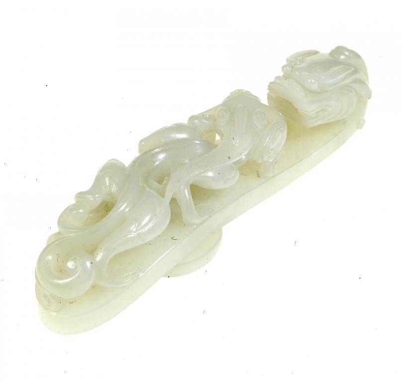 Appraisal: A CHINESE JADE BELT HOOK carved with a chilong cm