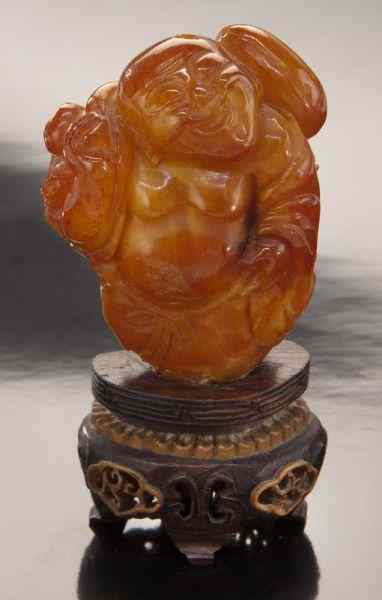 Appraisal: Chinese Qing carved Mila amber Maitreya Buddha ''H Circa -