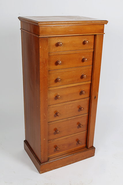 Appraisal: A LATE VICTORIAN BIRCH WELLINGTON CHEST fitted seven drawers with