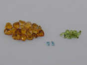 Appraisal: A group of loose cut peridots citrines and aquamarines the