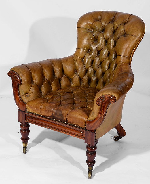 Appraisal: A WILLIAM IV LIBRARY ARMCHAIR upholstered in deep buttoned leather