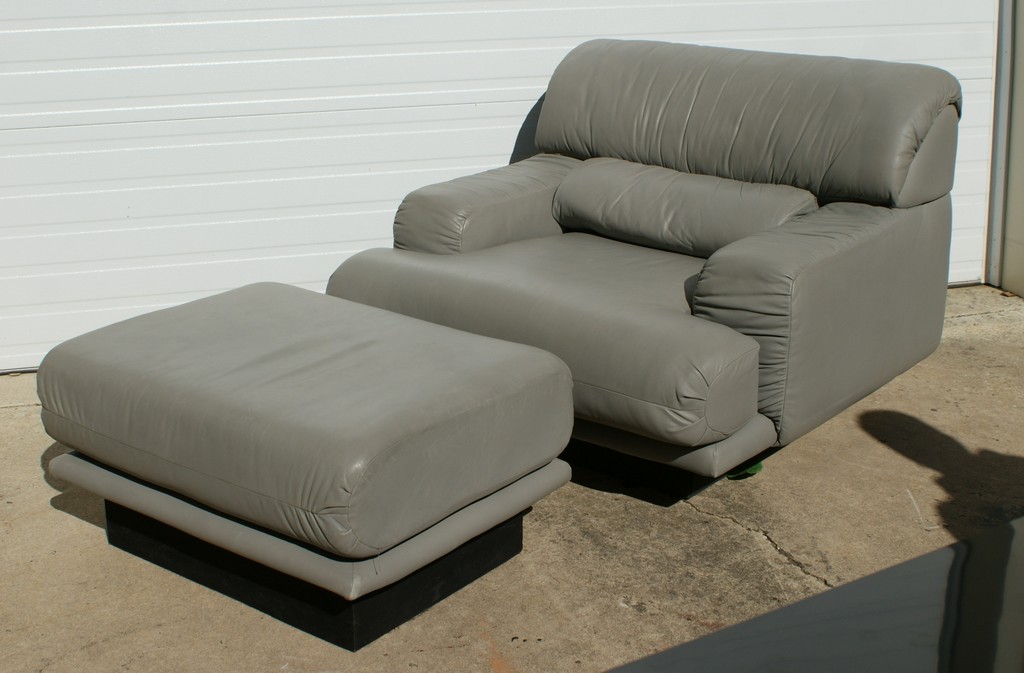 Appraisal: The Leather Center Gray Leather Arm Chair and Ottoman chair