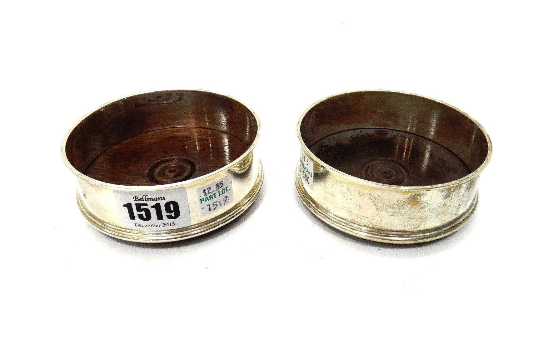 Appraisal: A pair of silver mounted circular bottle coasters each with