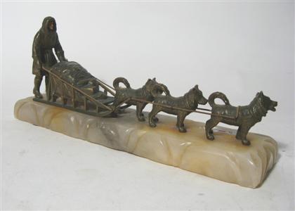 Appraisal: Bronze figure of a dog sled Modeled as an eskimo