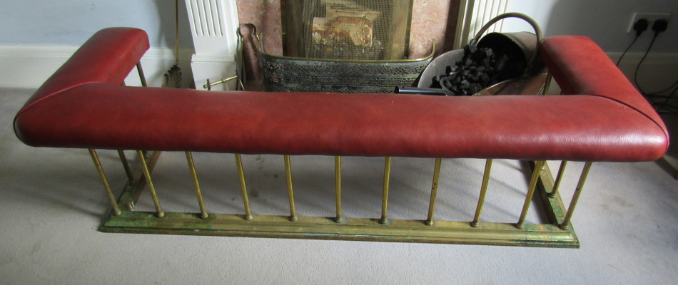 Appraisal: A brass club fender with red leather seat cm wide