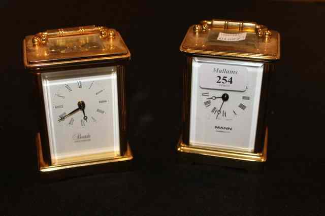 Appraisal: TWO MODERN BRASS CASED CARRIAGE CLOCKS with enamelled dials by