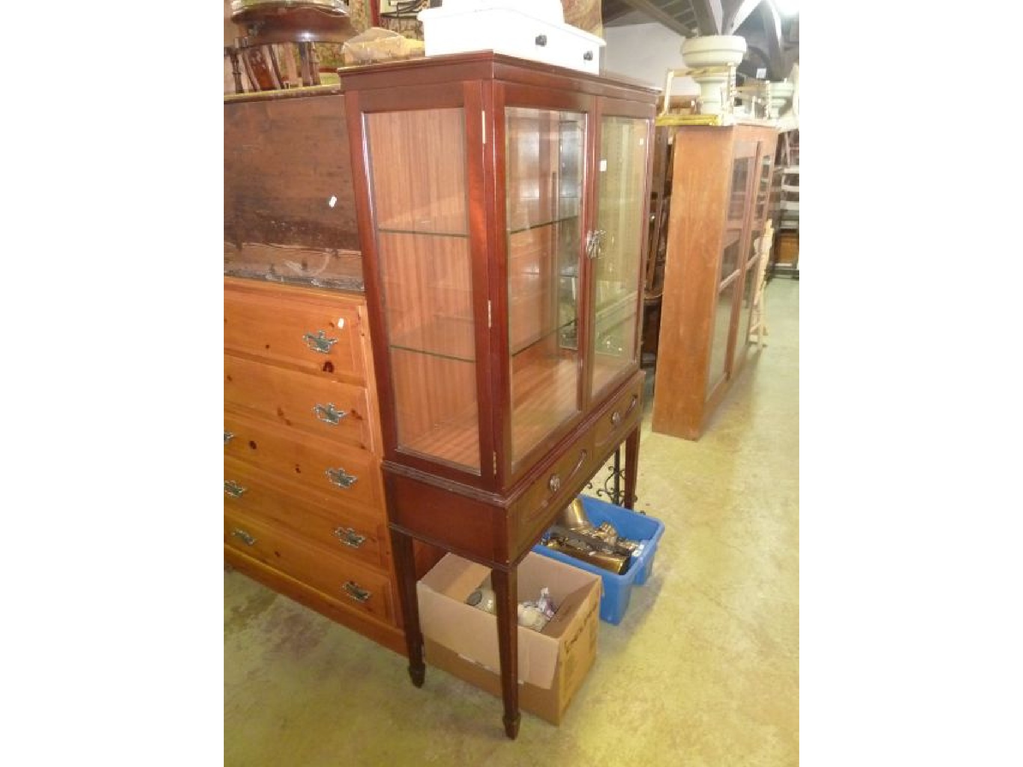 Appraisal: A mahogany cabinet on stand enclosed by glazed panelled doors