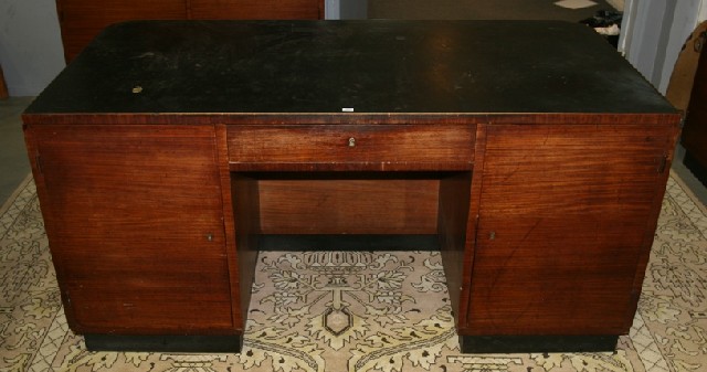 Appraisal: An Art Deco walnut veneered desk with leather insert top