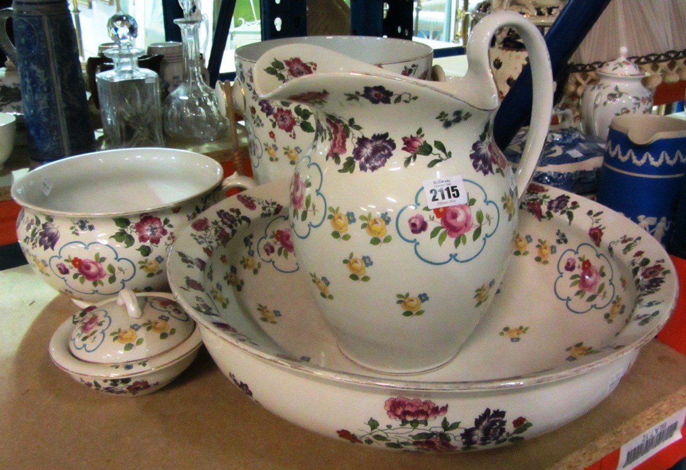 Appraisal: A five piece pottery wash set decorated with flowers