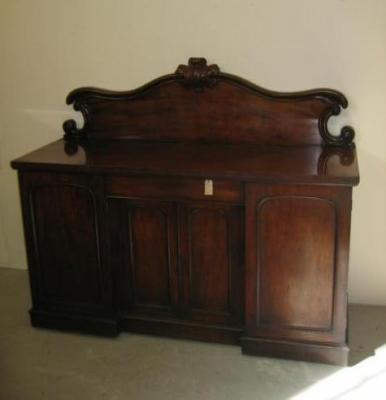 Appraisal: A VICTORIAN MAHOGANY SIDEBOARD the arched serpentine back with carved