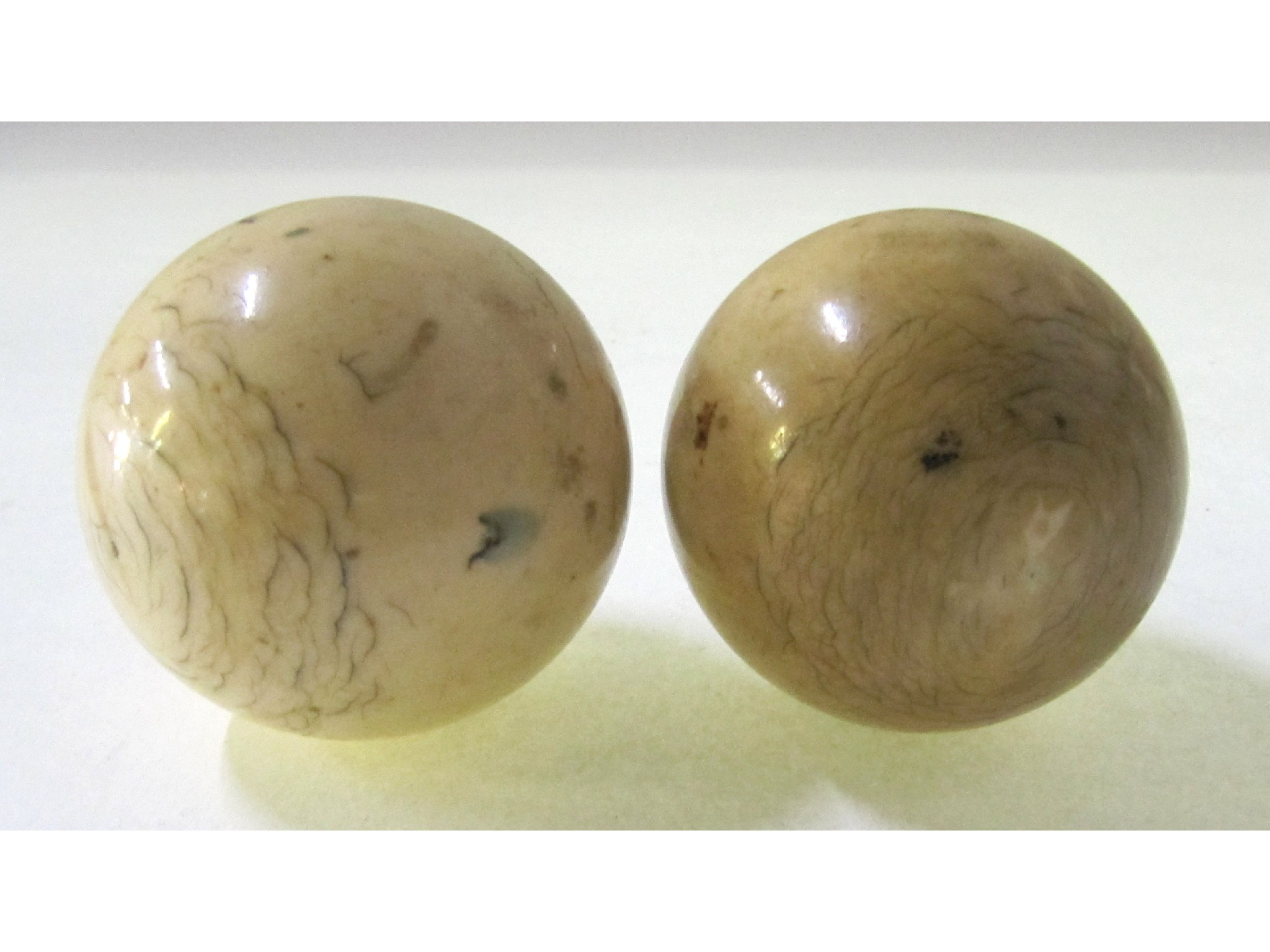 Appraisal: A lot comprising two ivory billiard balls each cm diameter