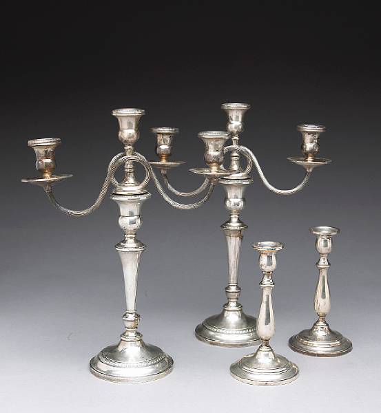 Appraisal: A pair of sterling weighted candlesticks with three light branches