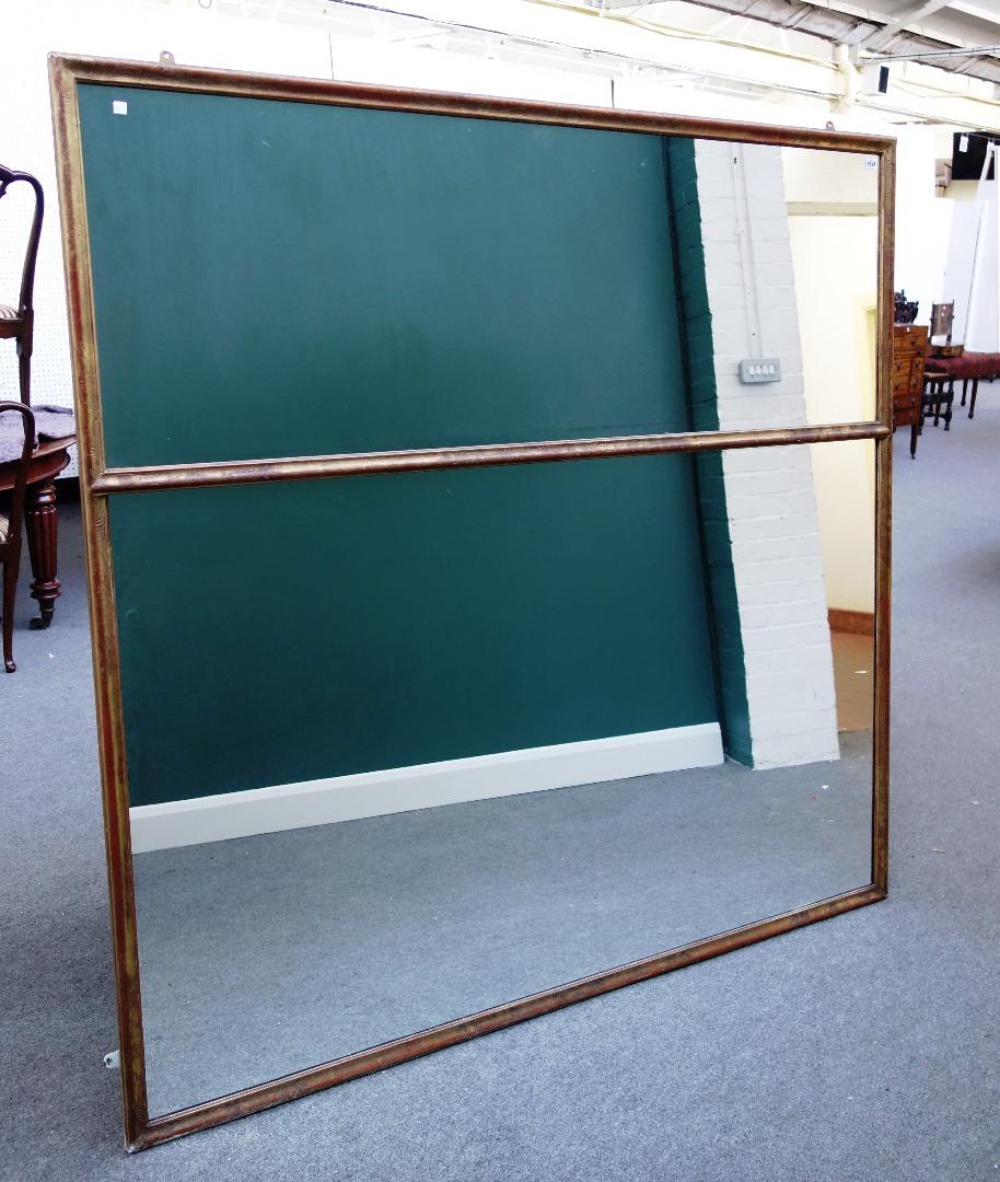 Appraisal: A large gilt framed rectangular two part wall mirror with