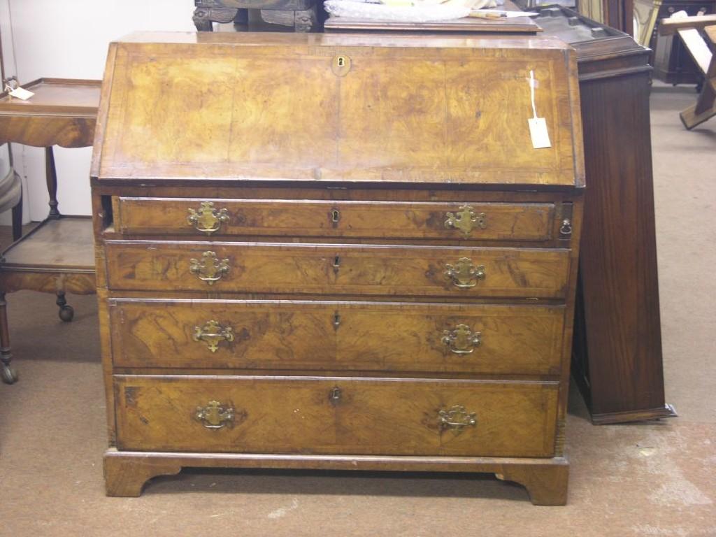 Appraisal: An early Georgian walnut bureau fall-front enclosing fitted interior with