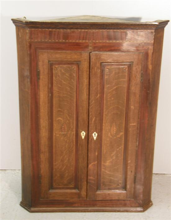 Appraisal: Oak and mahogany corner wall cupboard th century with herringbone