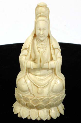 Appraisal: HAND CARVED FIGURE OF SOLID IVORY depicts a seated benevolent